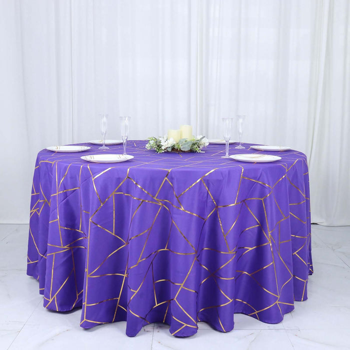 Purple tablecloth with gold geometric design on round table.