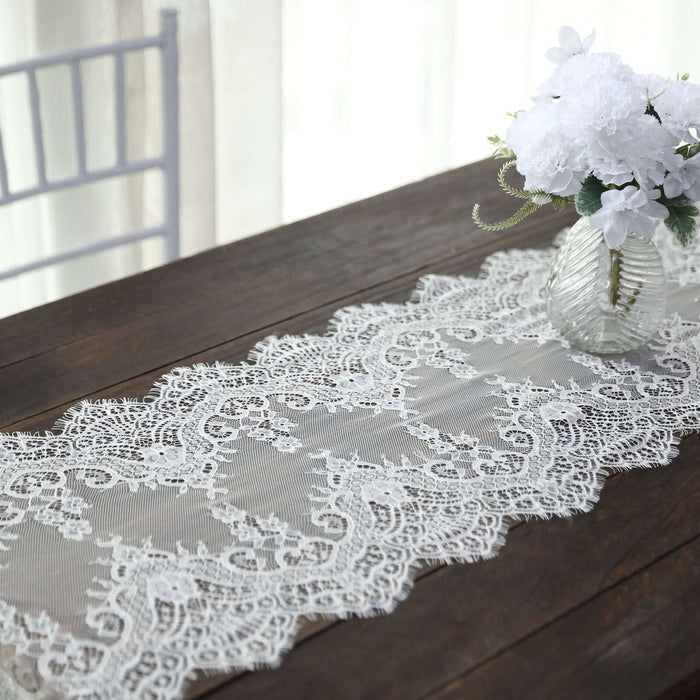 Lace table runner with floral centerpiece on a rustic wooden table.