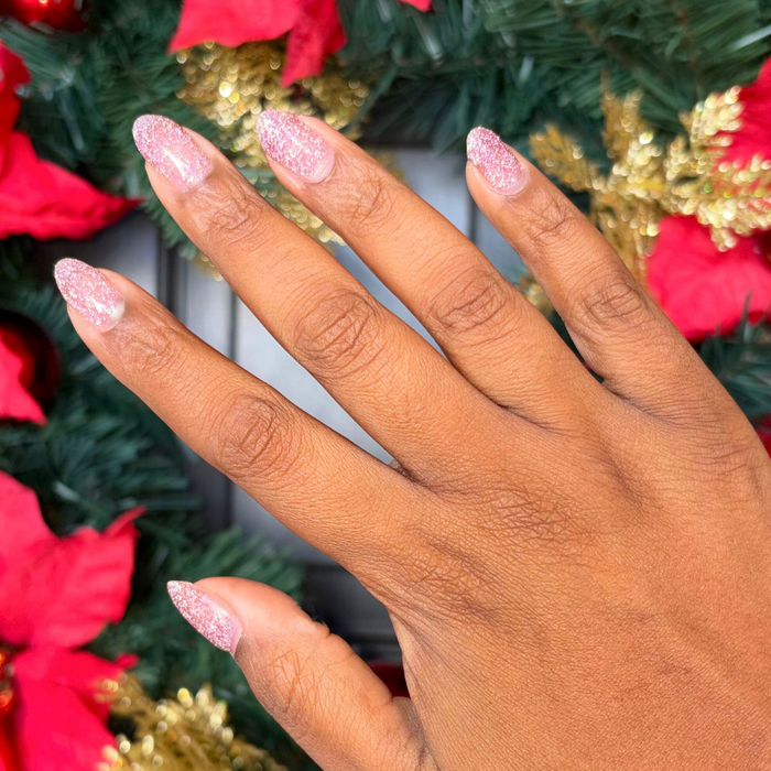 Hand with nails polished in Rosé Rhymes with Partay Gel showcasing sparkling cool-toned pink glitter manicure