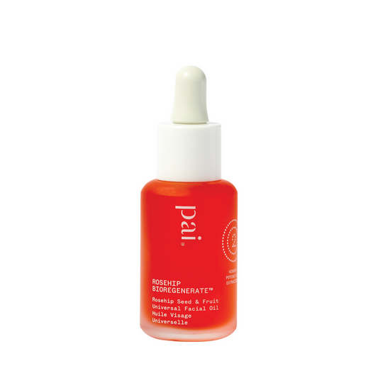 A glass bottle with a dropper on a white background containing red-colored Rosehip Bioregenerate Oil by Pai with Rosehip seed and fruit for universal skintypes
