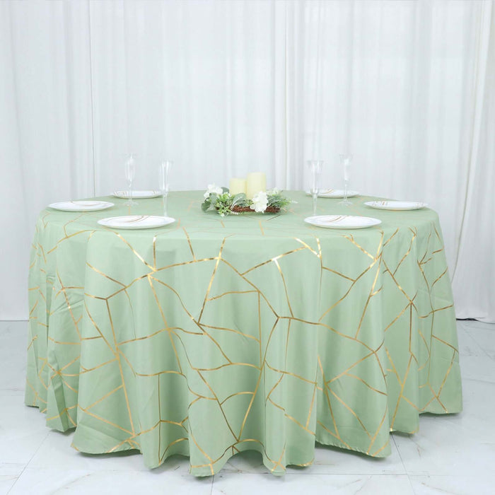 Round green tablecloth with gold geometric design on a banquet table.