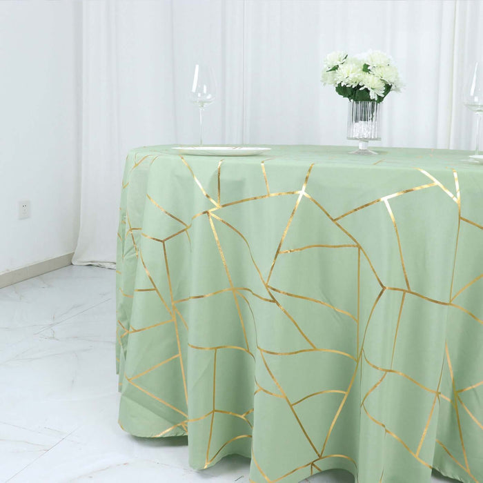 Green tablecloth with gold geometric pattern on a dining table.