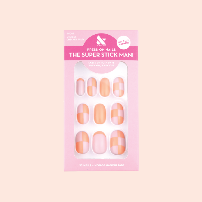 Sherbet Checker Party | Short | Round - Tab Press-On nails with peach and pastel pink checkerboard pattern in packaging on peach background
