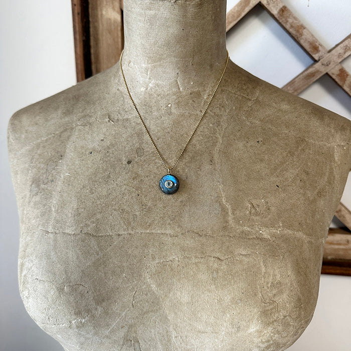 Gold vermeil necklace with round blue labradorite pendant and bezel-set topaz on thin chain.