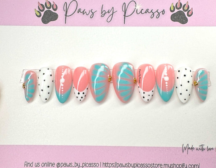 Nail art designs with pink and turquoise patterns on a white background, branded 'Paws by Picasso'.