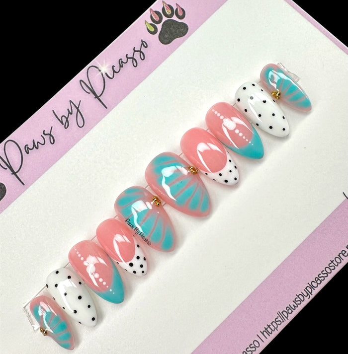 Set of decorative nail art designs on a pink 'Paws by Picasso' branded card.