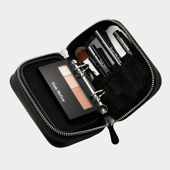 Makeup set with a black case on a light gray background