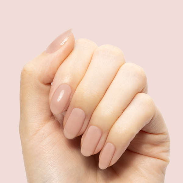The Queen Takes Her Tea With Milk - Gel shown on hand with neutral mauve glossy nails for a soft manicure by Olive and June