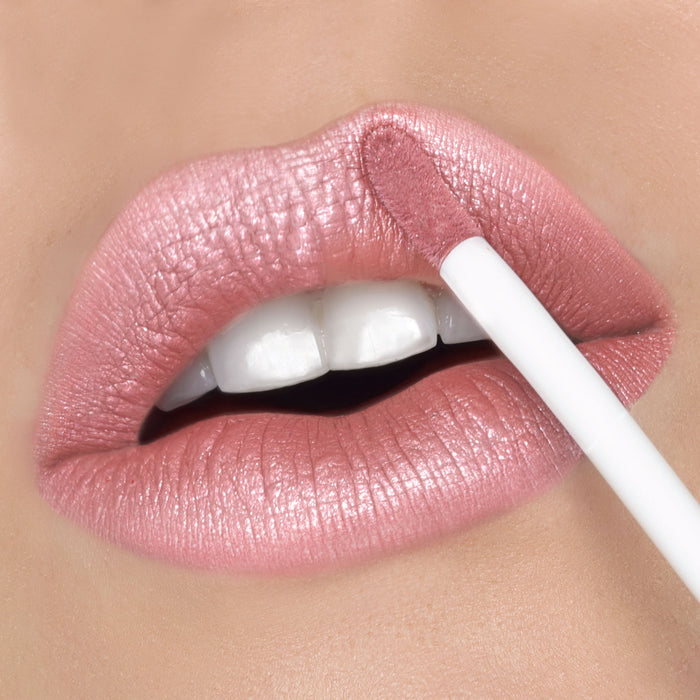Close-up of a woman's lips with a fair skin tone wearing Runway Rogue's Silk Glam liquid lipstick in shade 'Trophy Wife', a frosted pale pink liquid lipstick with a pearlescent shimmer finish.