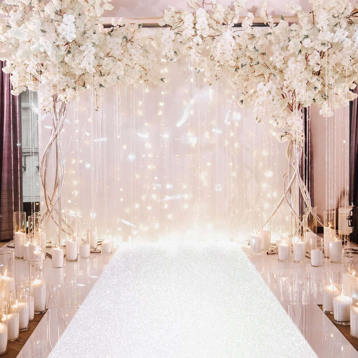 Elegant wedding backdrop with floral arrangements and candles.