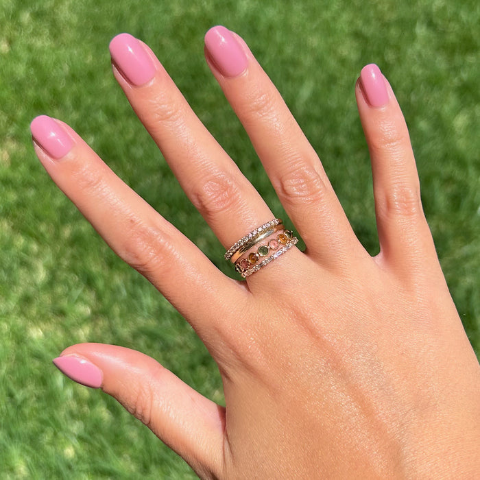 World Lit - Press-On | Extra Short | Round showing hand with mauve extra short round press-on manicure outdoors in sunlight